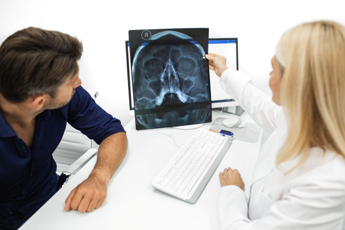 doctor and patient examining sinus scan