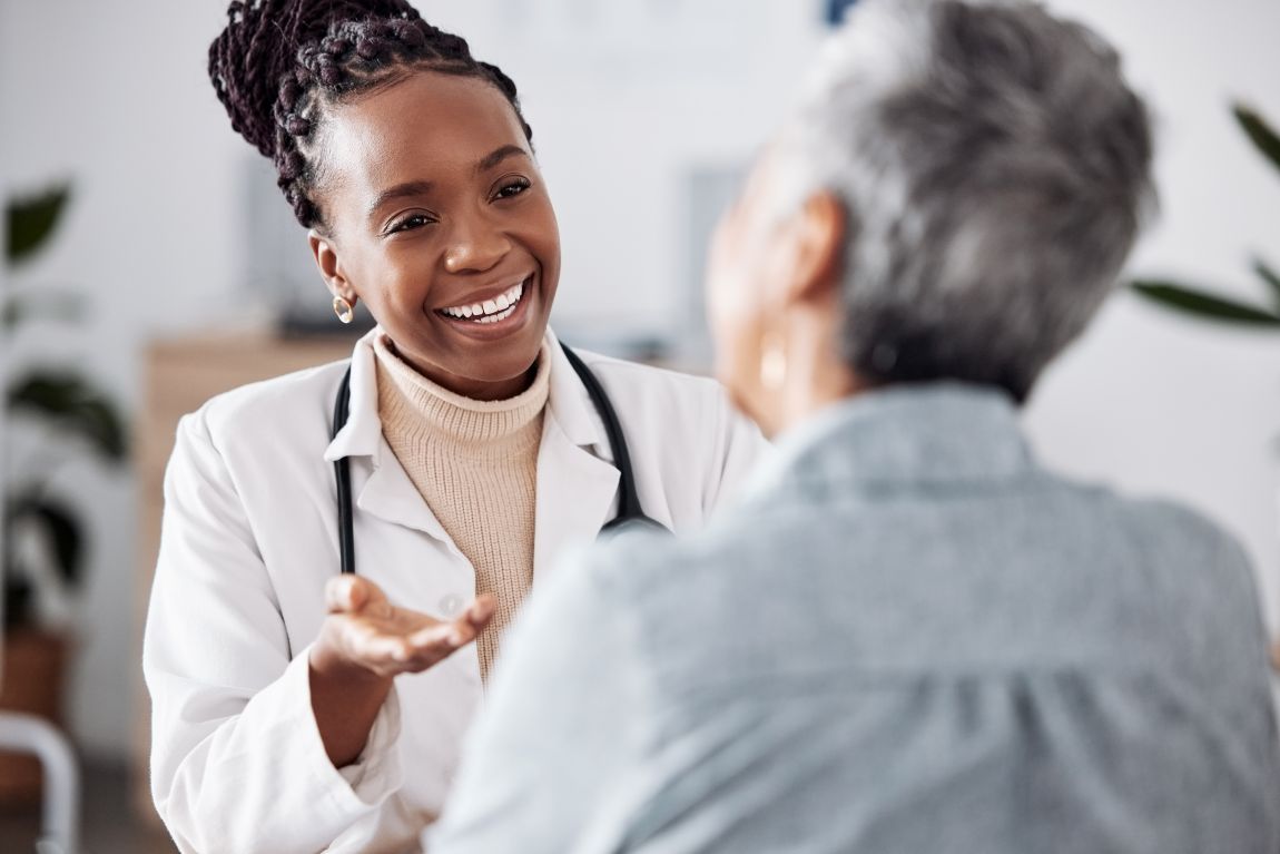 physician smiling talking to patient